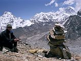 Gokyo 4 Nameless Fangs 7 Jerome Ryan Having Snack With Everest And Glaciers Below Jerome Ryan stopped at a cairn to have a snack while descending the Nameless Fangs north of Gokyo, with views towards Everest and glaciers below.